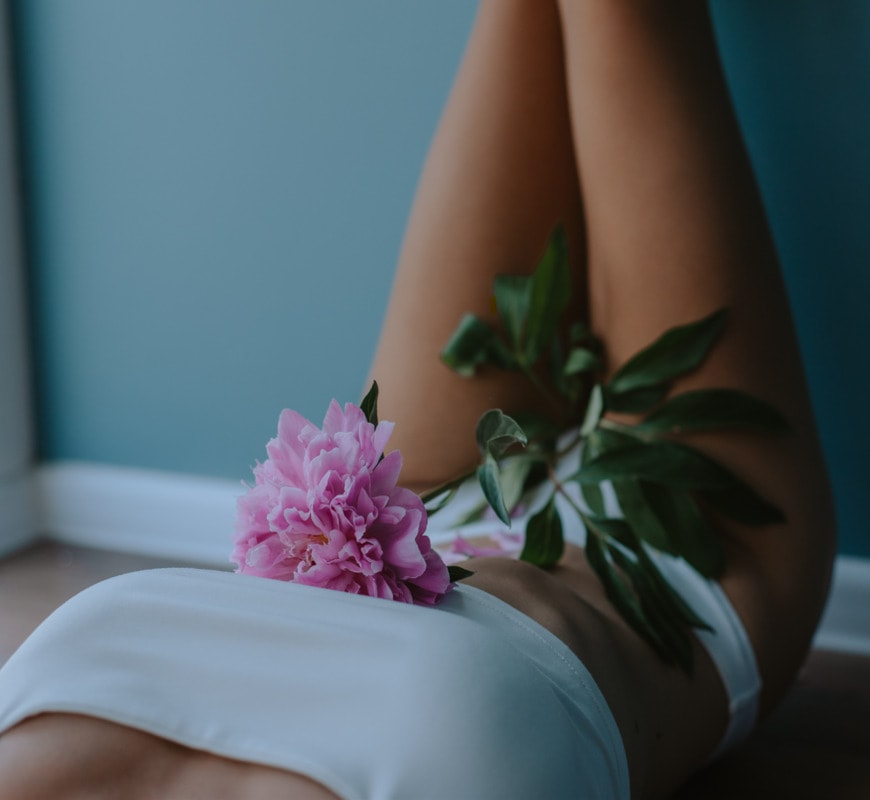 žena sa cvetom na krilu